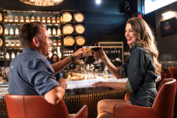 Couple toasting cocktails at Blackland Distillery, commercial photography Dallas, Texas