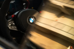 BMW M steering wheel detail with logo, automotive photography Austin, Texas