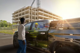 Dallas College commercial photography, student sees future self as construction worker reflected in truck, Dallas, Texas