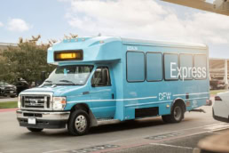 DFW Airport Express shuttle bus Ford E-450 at Terminal A, commercial photography Dallas, Texas