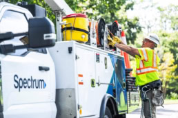 Spectrum field technician retrieving cable from service truck, commercial photography Dallas, Texas