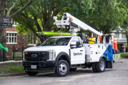 Spectrum Ford F-450 Super Duty bucket truck on Cathedral Drive, commercial photography Dallas, Texas