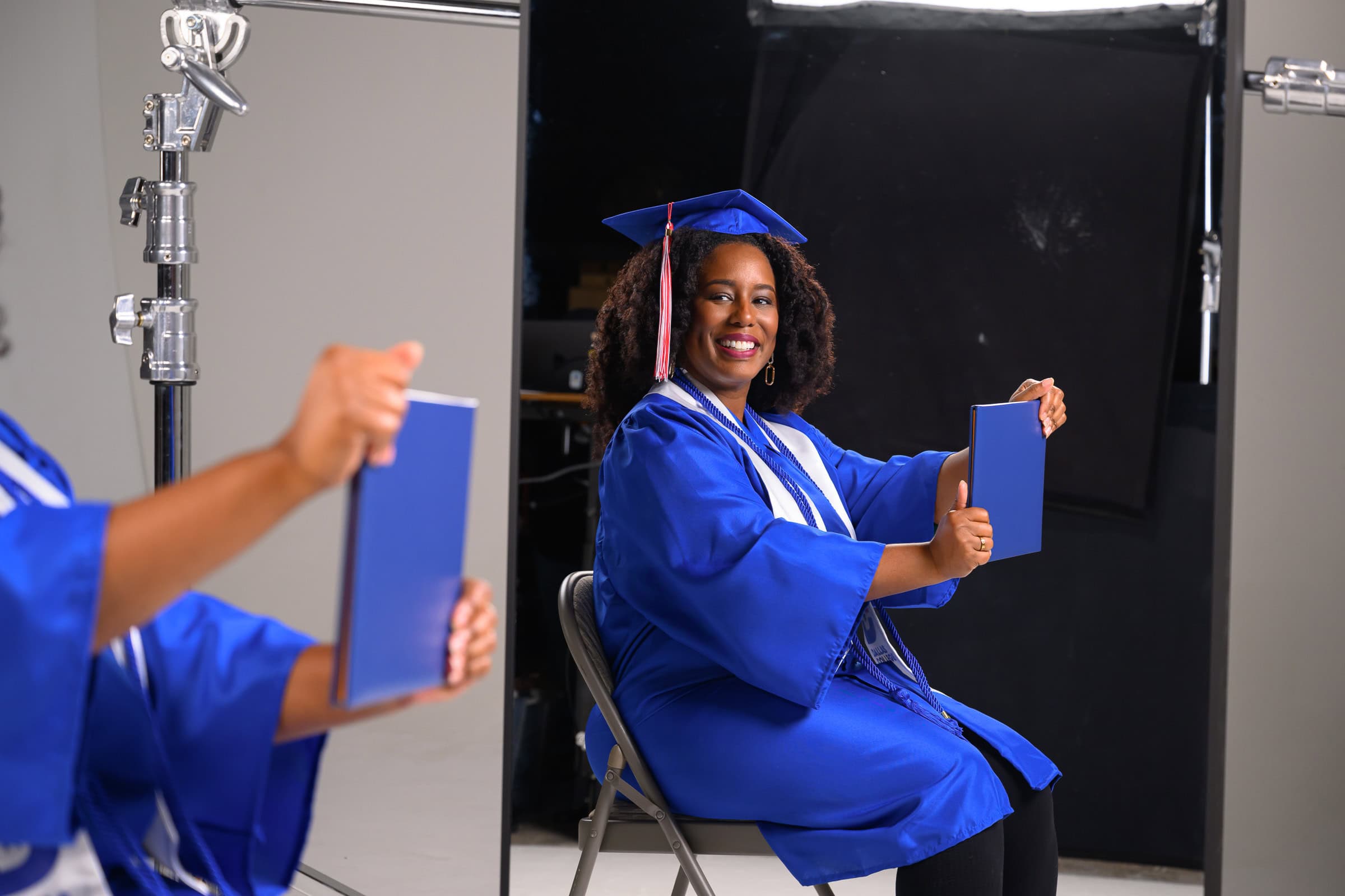College graduate in cap and gown holding a diploma, higher education photography in Dallas, Texas by David Loi Studios