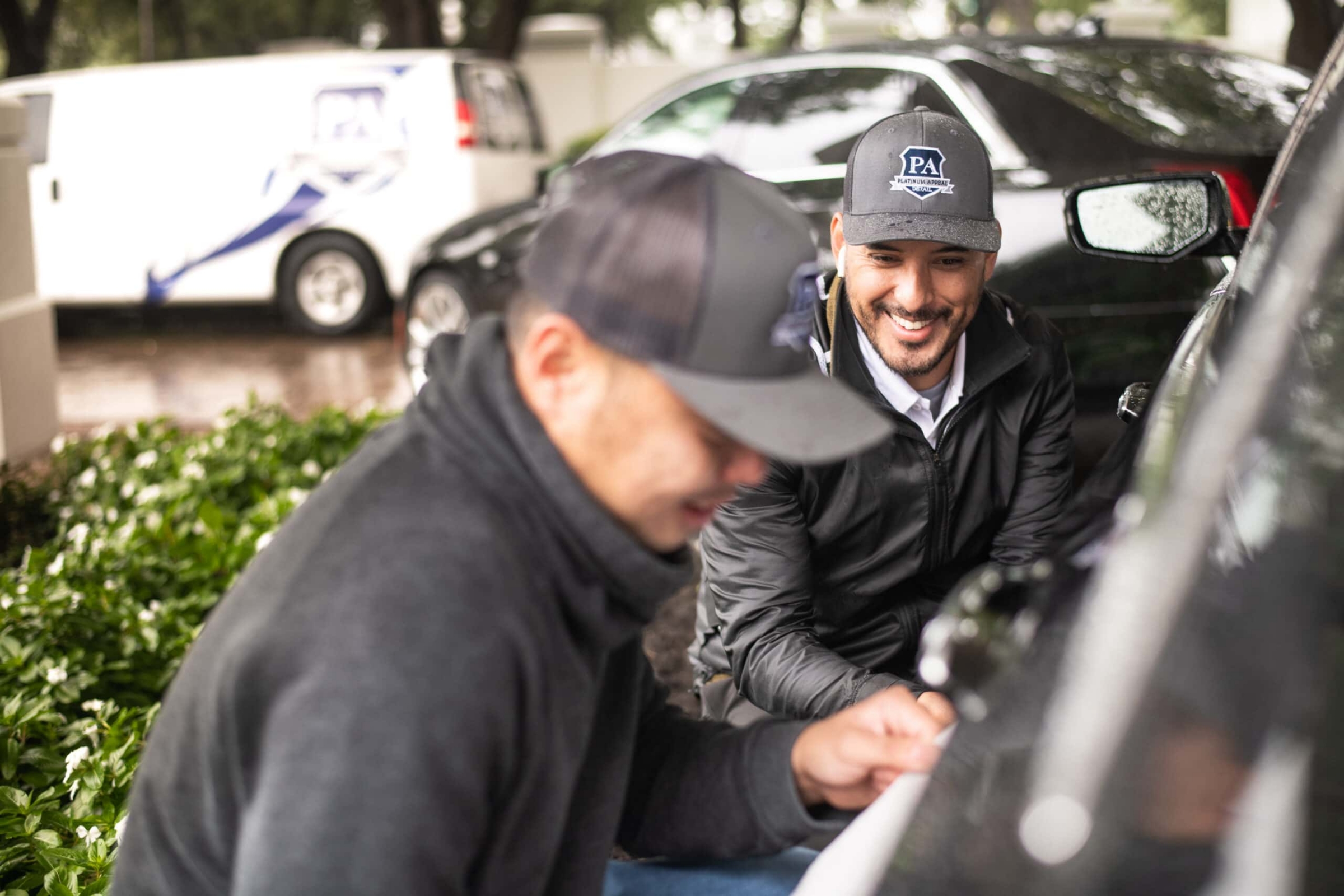 Two auto detailing technicians working on a vehicle, commercial photography Dallas, Texas