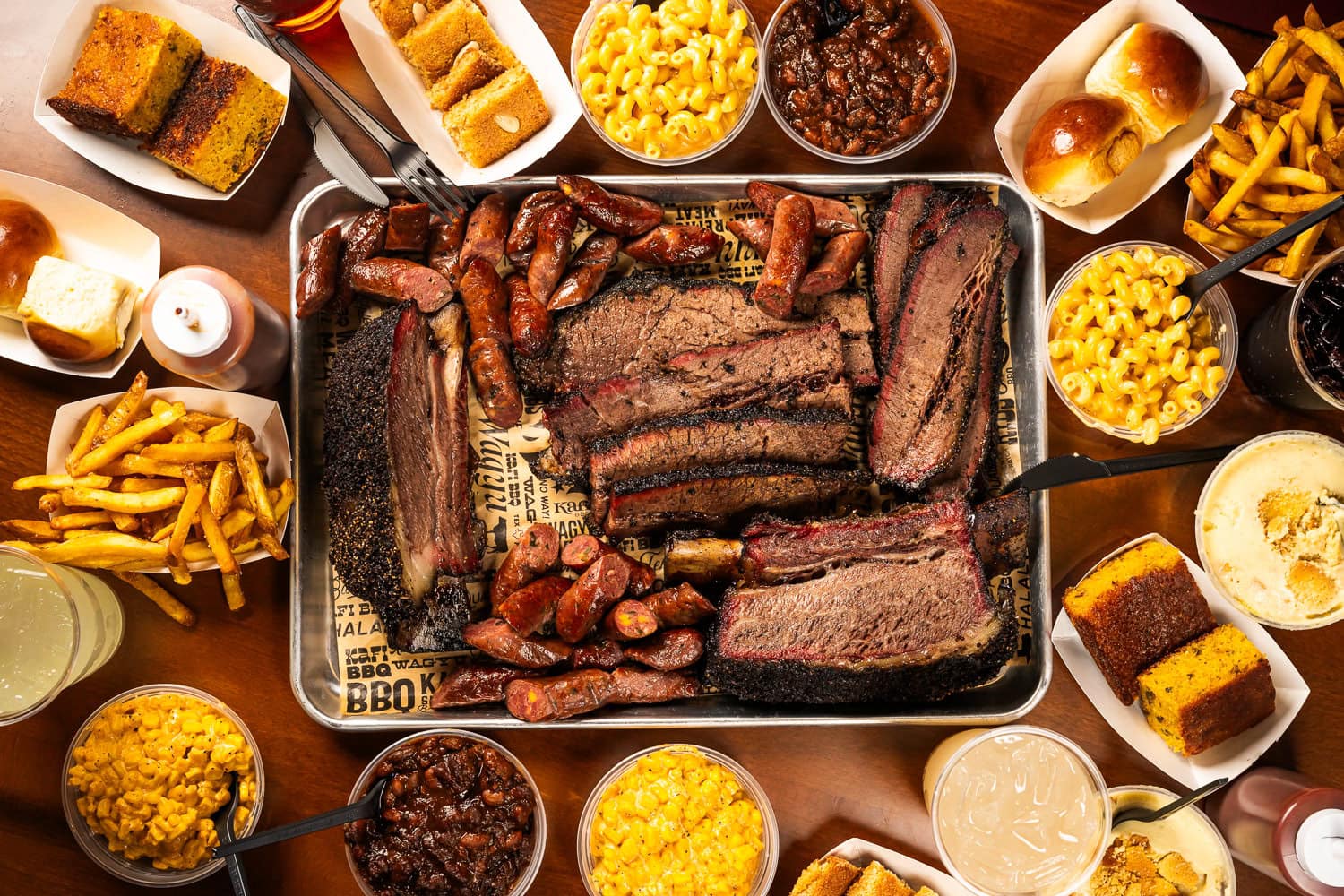 BBQ spread with brisket sausage and sides, commercial food photography Dallas, Texas