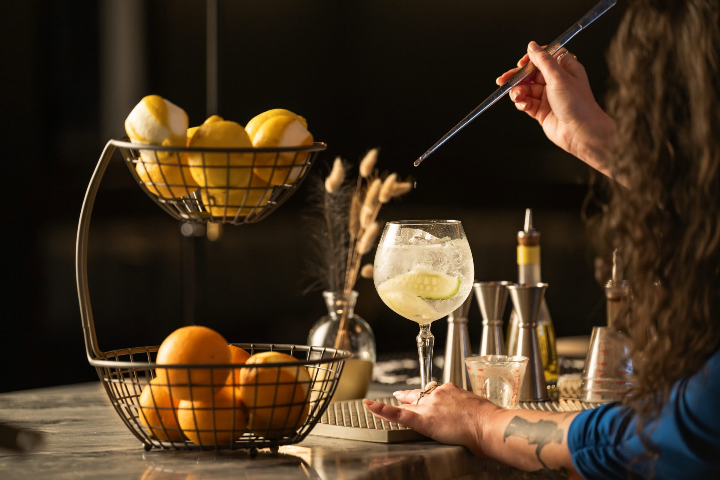 Bartender crafting a gin and tonic cocktail at Blackland Distillery, commercial photography Fort Worth, Texas