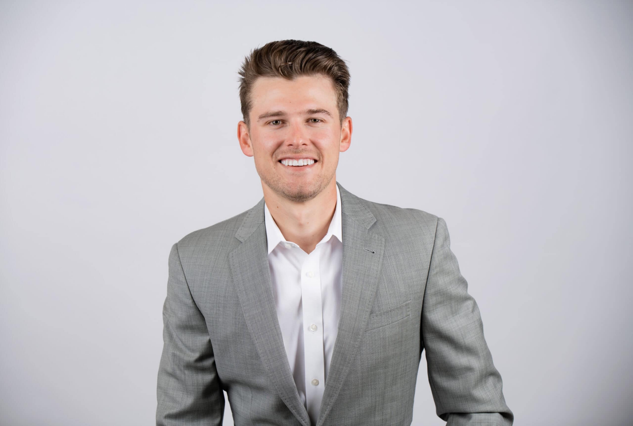 Corporate headshot of a young professional in a gray suit, headshot photography in Addison, Texas by David Loi Studios