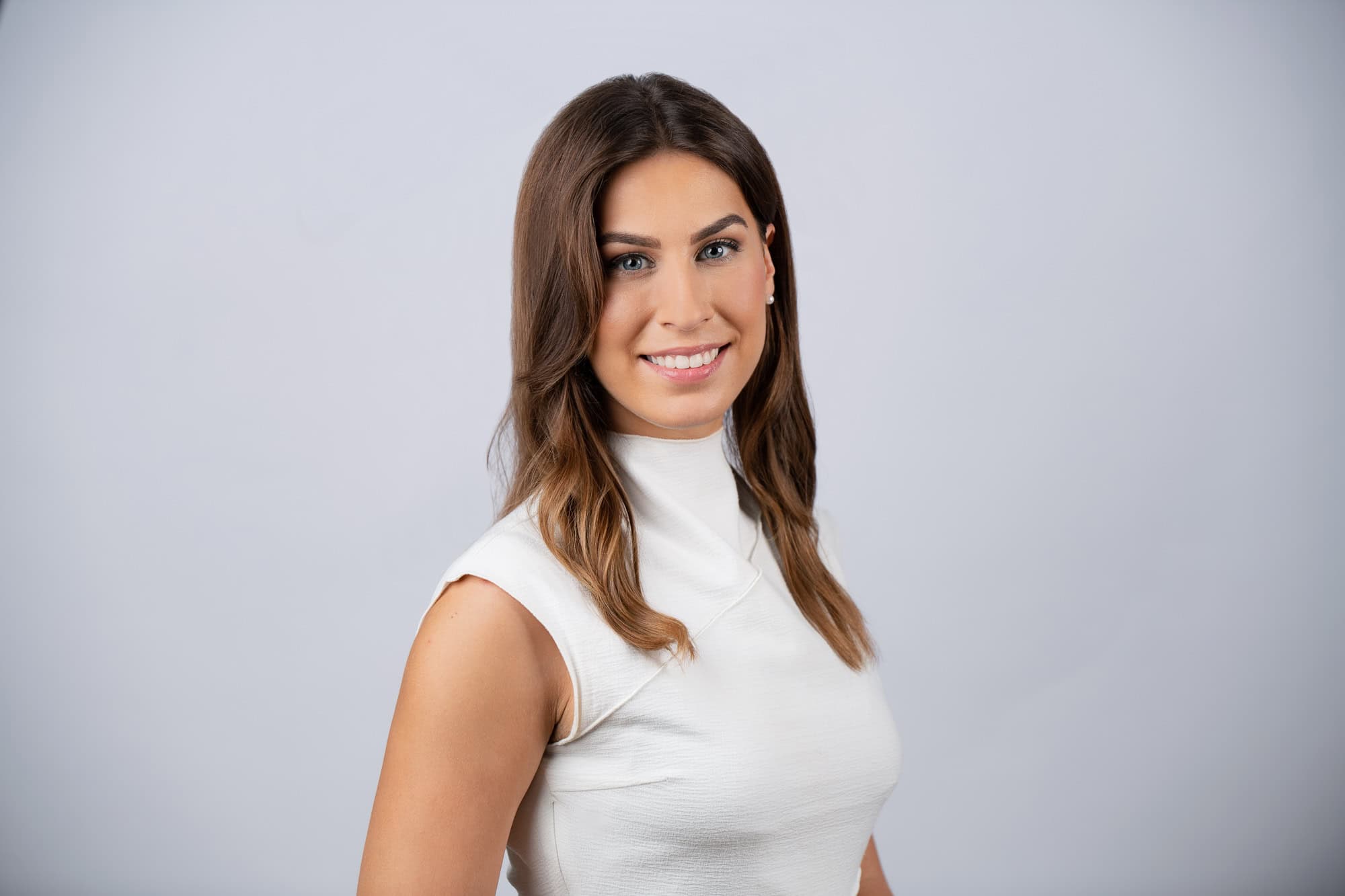Corporate headshot of a professional woman in a white top, headshot photography in Addison, Texas by David Loi Studios