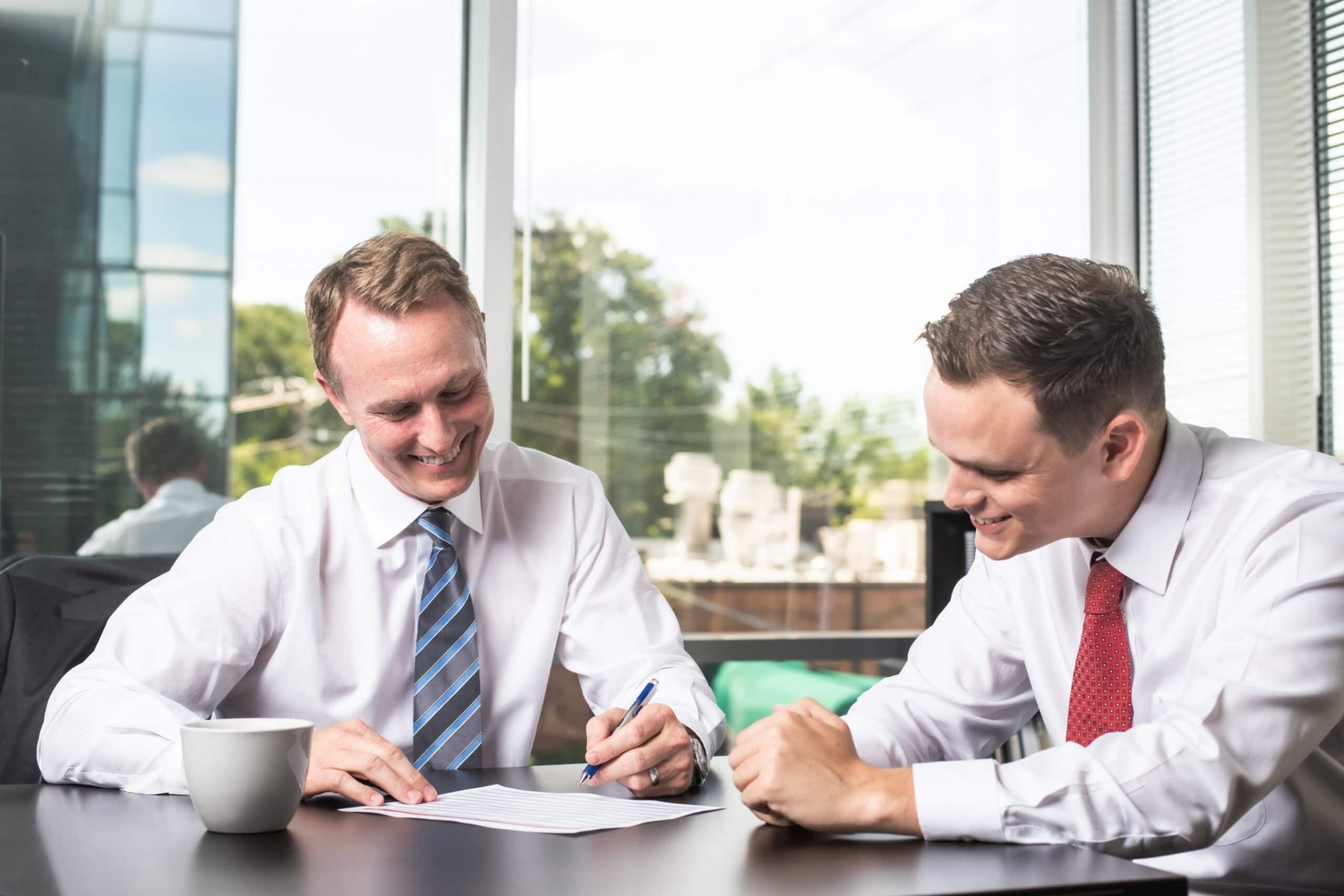 Two businessmen reviewing documents, corporate portrait photography Dallas, Texas