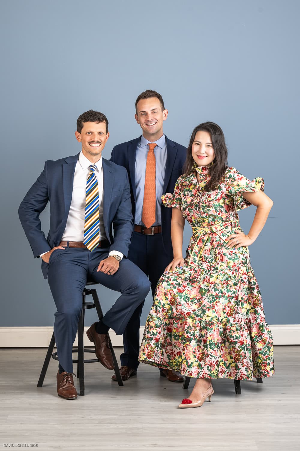 Three professionals in business attire, corporate team portrait photography