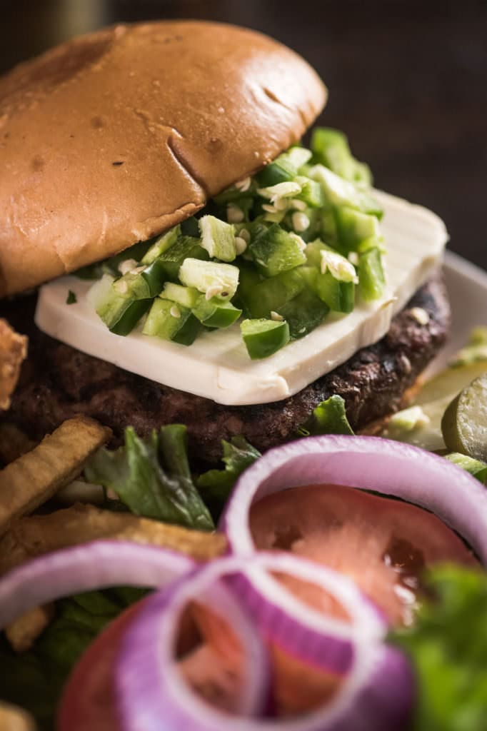 Jalapeño cheeseburger with red onion and fries, Deep Ellum food photography Dallas, Texas