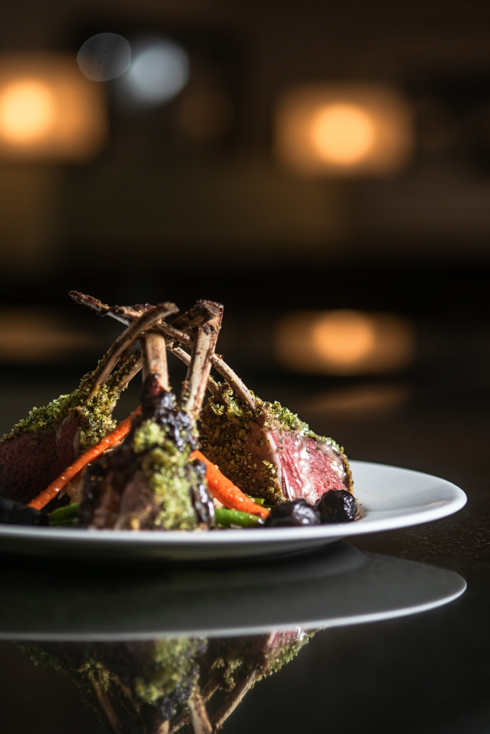 Herb-crusted rack of lamb with roasted vegetables, commercial culinary photography