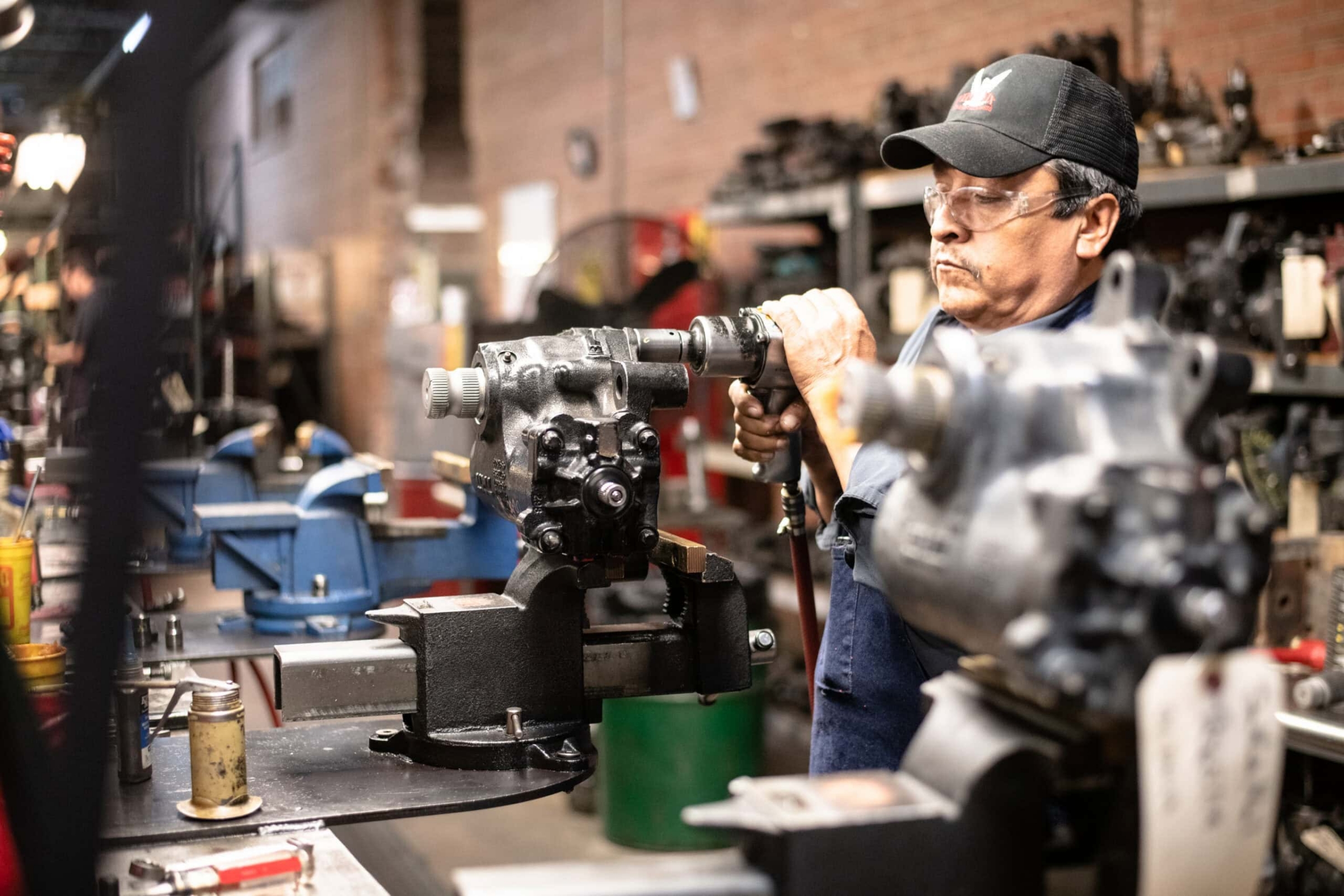 Machinist working on hydraulic pump in industrial workshop, industrial photography Dallas, Texas