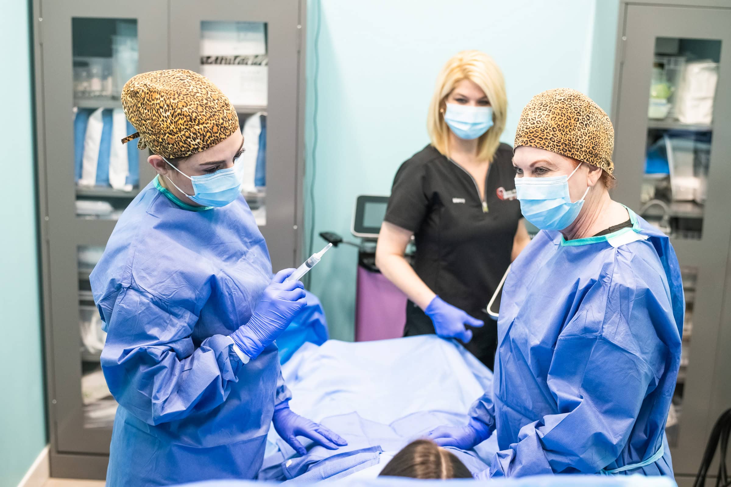 Medical team in surgical gowns performing a procedure, clinical team commercial medical photography in Dallas, Texas by David Loi Studios