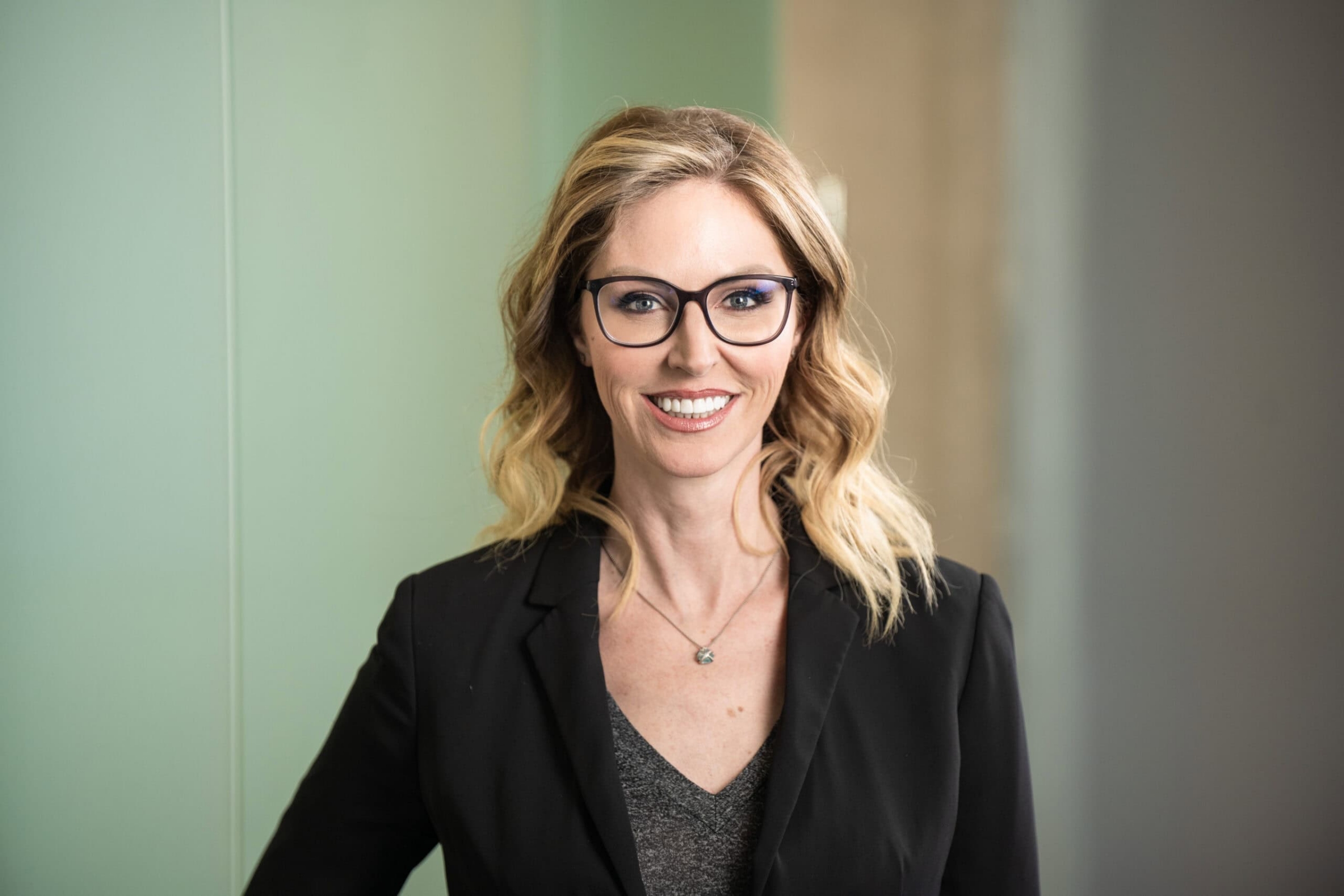 Businesswoman in modern executive setting, commercial corporate branding photography by David Loi Studios