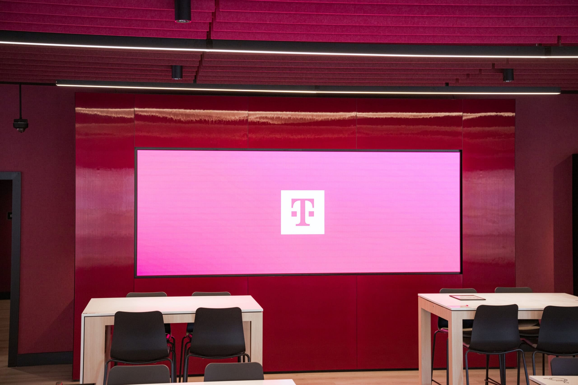 T-Mobile corporate event space with large branded screen, commercial photography Dallas, Texas