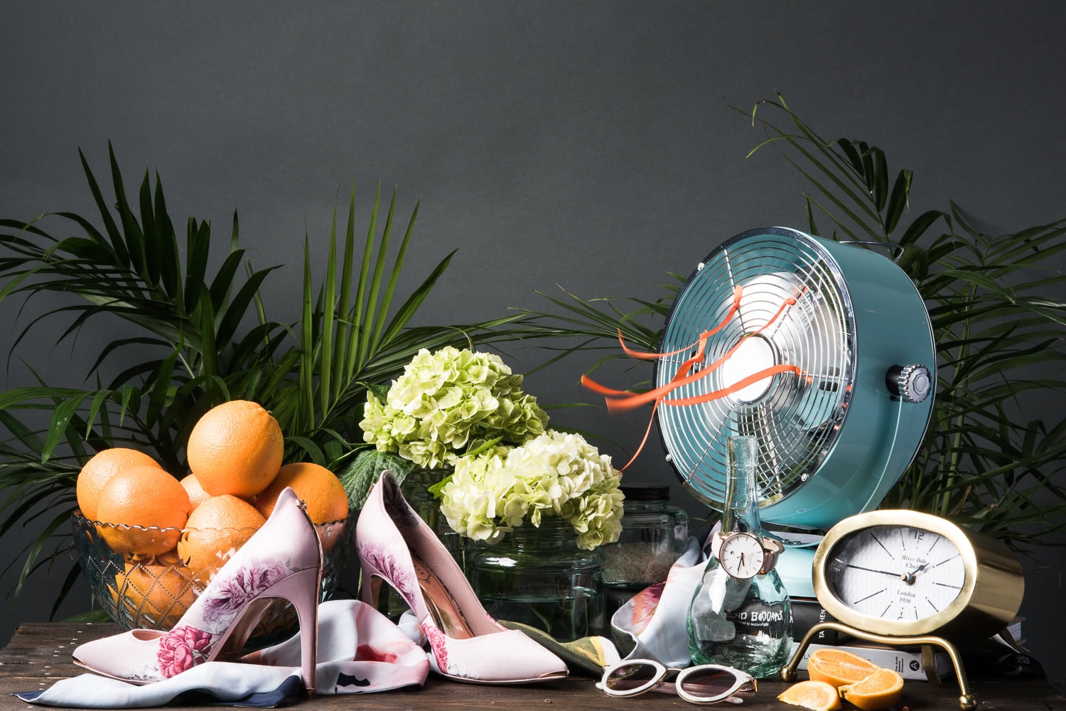 Ted Baker floral heels styled with oranges and a vintage fan, lifestyle product photography in Dallas, Texas by David Loi Studios